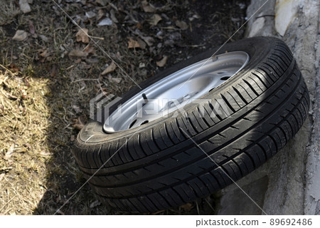 New tire with rubber on the iron disc of the car New tire with rubber on the iron disc of the car 89692486