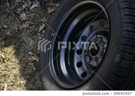 New tire with rubber on the iron disc of the car New tire with rubber on the iron disc of the car 89692487