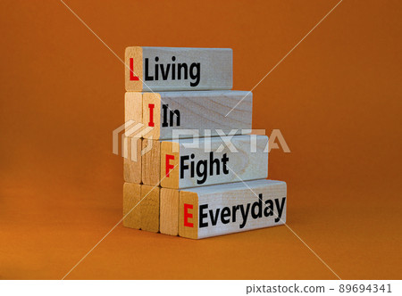LIFE living in fight everyday symbol. Concept words LIFE living in fight everyday on wooden blocks on a beautiful orange background. Business LIFE living in fight everyday concept. Copy space. 89694341