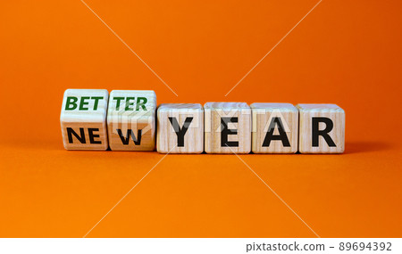 Better new year concept. Fliped cubes and changed the words 'new year' to 'better year'. Beautiful orange background. Business and better new year concept. Copy space. 89694392