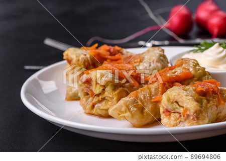 Cabbage rolls stuffed with ground beef and rice served on a white plate Cabbage rolls stuffed with ground beef and rice served on a white plate 89694806