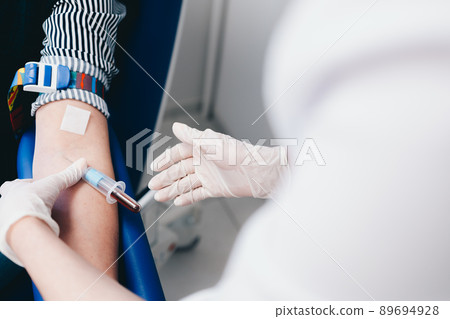 The patient takes a blood test at the clinic. The patient takes a blood test at the clinic. 89694928
