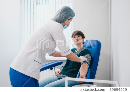 The patient takes a blood test at the clinic. The patient takes a blood test at the clinic. 89694929