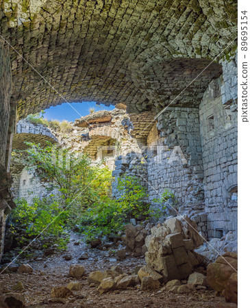 Collapsing tower of fortress Kosmac. Ancient Austro-Hungarian fortress built as a defensive structure and an observation post. Montenego Collapsing tower of fortress Kosmac. Ancient Austro-Hungarian fortress built as a defensive structure and an observation post. Montenego 89695154