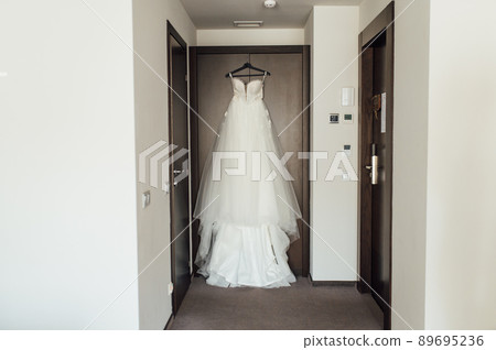White Wedding dress on a shoulders, before ceremony 89695236