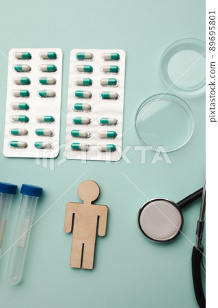 Stethoscope, syringes, blood sample and pills on blue background, healthcare concept. Vertical image 89695801