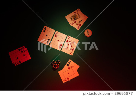 Table with poker game, top view. Dice and playing cards are on a green background 89695877