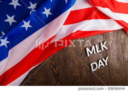 the word MLK day laid with silver metal letters on wooden surface with crumpled USA flag at upper side the word MLK day laid with silver metal letters on wooden surface with crumpled USA flag at upper side 89696444