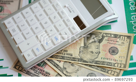 Business report in cash dollars charts and calculator on table 89697293