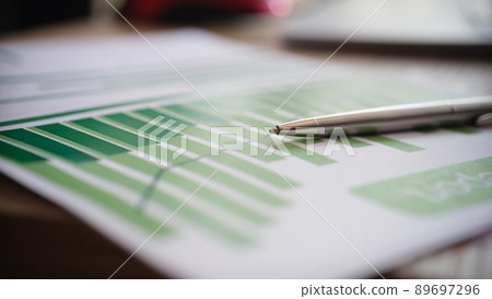 Paper document with pen graphs and diagrams Paper document with pen graphs and diagrams 89697296