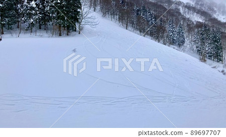 A spur on a slope with fresh snow at a ski resort called Kandatsu Snow Resort A spur on a slope with fresh snow at a ski resort called Kandatsu Snow Resort 89697707