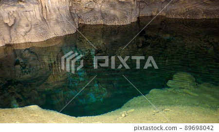 A blue underground lake in a natural limestone cave that is not a facility on the main island of Okinawa A blue underground lake in a natural limestone cave that is not a facility on the main island of Okinawa 89698042