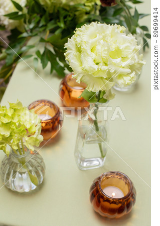 A table decorated with a single flower, warm colors, hydrangea and eustoma 89699414