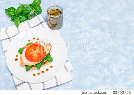 Sandwich with chicken, mozzarella, tomato, pesto and basil on toasted ciabatta, horizontal, top view 89700798