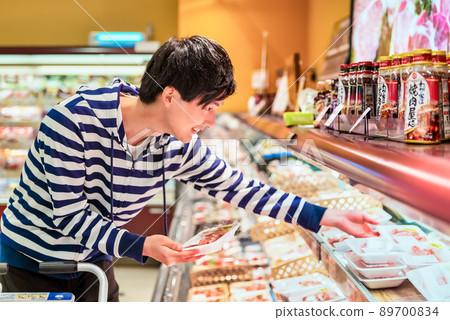 Young man buying meat at the supermarket Young man buying meat at the supermarket 89700834