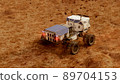 Martian rover drives across the rocky surface, observing the colonists base inside of the crater. 4K footage 89704153