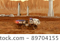 Martian rover drives across the rocky surface, observing the colonists base inside of the crater. 4K footage 89704155