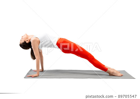 Slim woman does yoga, upward plank pose, Purvottanasana, isolated on white. 89705547