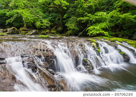Beautiful scenery of the clear stream Kikuchi Gorge waterfall flowing in the early summer rain 89706289