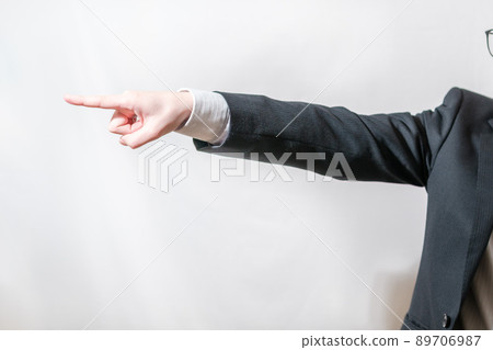 A businessman pointing to the left A businessman pointing to the left 89706987