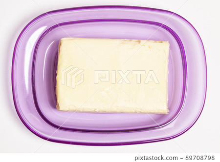 Butter in a plastic butter dish isolate on a white background 89708798