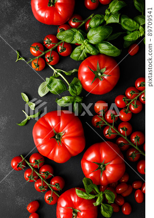 Tomatoes and basil on black background, top view, flat lay 89709541
