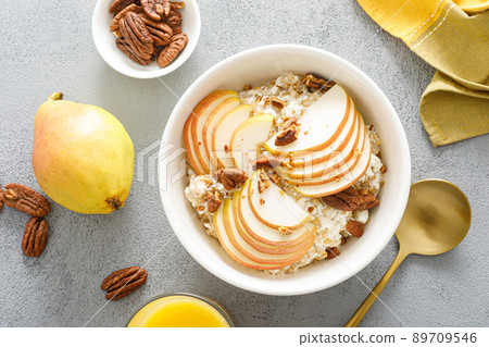 Oatmeal with cottage cheese, pecan nuts and pear for breakfast 89709546