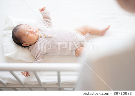 Sleeping baby over a woman Sleeping baby over a woman 89710988