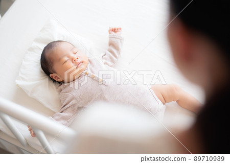 Sleeping baby over a woman Sleeping baby over a woman 89710989