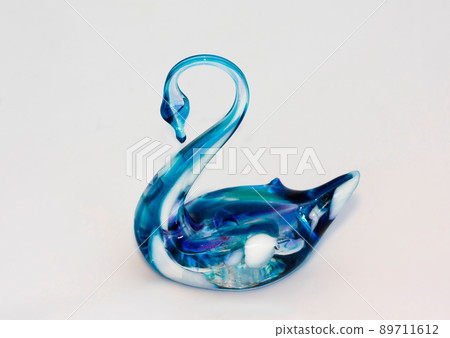 Glass swan figurine on white background Glass swan figurine on white background 89711612