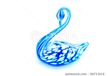 Glass swan figurine on white background 89711618