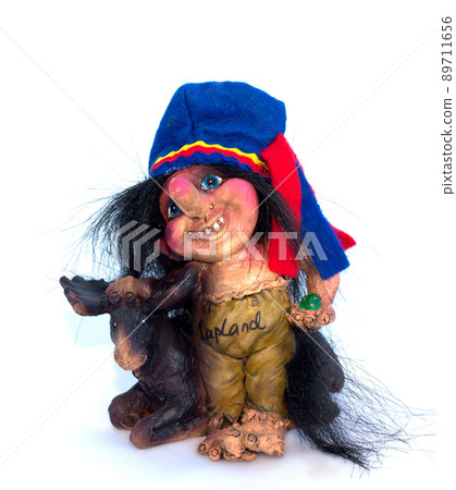Lapland souvenir, Troll with elk figurine on white background Lapland souvenir, Troll with elk figurine on white background 89711656