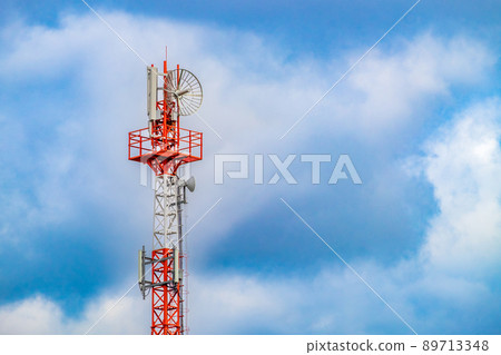 Radio mast (tower) with antennas for telecommunications and broadcasting and cloudy sky. Close-up 89713348