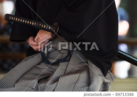 A person holding a Japanese sword A person holding a Japanese sword 89713386