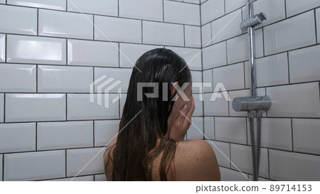 Sad depressed girl crying in shower under running water back view close up. Woman in bathroom being unhappy without clothes. Dramatic concept of woman sadness Sad depressed girl crying in shower under running water back view close up. Woman in bathroom being unhappy without clothes. Dramatic concept of woman sadness 89714153
