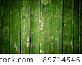 Old wooden green background of boards with cracked and peeling paint. Wooden texture. Fence 89714546