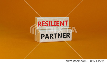Resilient partner symbol. Concept words Resilient partner on wooden blocks on a beautiful orange table orange background. Business resilience and resilient partner concept, copy space. Resilient partner symbol. Concept words Resilient partner on wooden blocks on a beautiful orange table orange background. Business resilience and resilient partner concept, copy space. 89714594