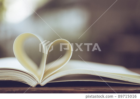 Close up heart shape from paper book on wooden table 89715016