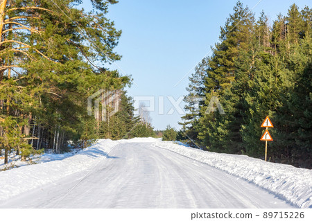 Road in Russia forest with covered snow. Winter time. Landscape 89715226