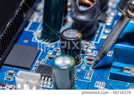 Repairman is soldering the motherboard of electronic device.. 89716178