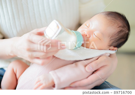 Baby drinking milk while sleeping Baby drinking milk while sleeping 89716700