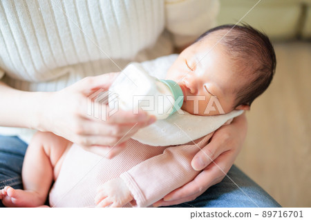Baby drinking milk while sleeping Baby drinking milk while sleeping 89716701
