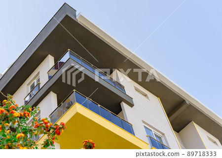 A low angle shot of a corner section of a modern building under the sky 89718333
