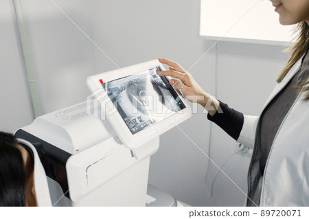 Focus on a special optical equipment. Optician checking sight in special machine. New ophthalmological technology. 89720071
