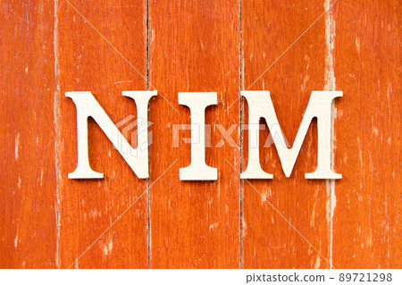 Alphabet letter in word NIM (Abbreviation of Net interest margin) on old red color wood plate background 89721298