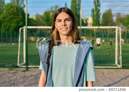 Outdoor portrait of student boy 17, 18 years old, in sunset on school football field Outdoor portrait of student boy 17, 18 years old, in sunset on school football field 89721896