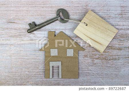 House model and key on wooden desk. Directly above. Flat lay. 89722687