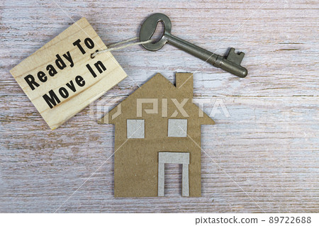 Ready to move in text on wooden keychain with house model and key on wooden desk 89722688