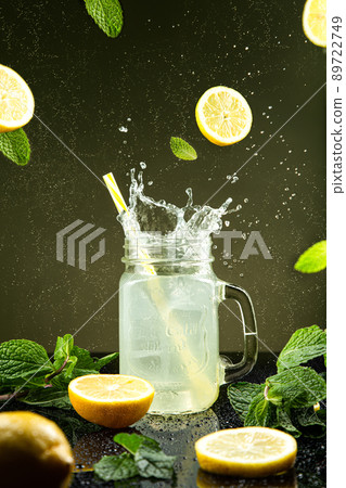 Lemonade splash on dark background. 89722749