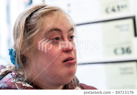 Close up expressive portrait of a 39 year old white woman with Down Syndrome Close up expressive portrait of a 39 year old white woman with Down Syndrome 89723176
